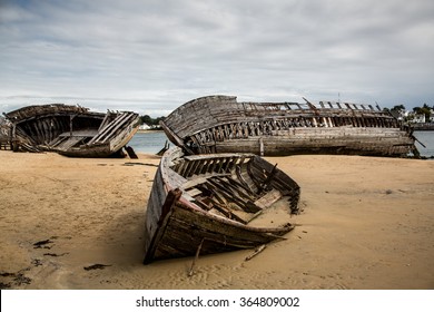 Abandoned wooden boat wreck on the sandy beach at boat cemetary, Le Magouer, Riviere d'Etel, Normandy, France