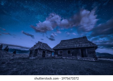 Abandoned wooden houses on a hill under the night starry sky in carpathian mountains. - Powered by Shutterstock