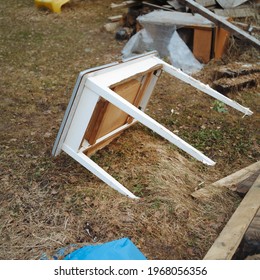 Abandoned Wooden Table With Broken Leg In The Messy Backyard