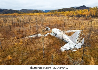 Abandoned wreck plane in a swamp in Russia. Autumn photo
