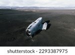 Abandoned wreck of US Navy Douglas DC-3 in Solheimasandur in south part of Iceland. Aerial view of one of the most visited location by tourist. Beach at Sólheimasandur, in the South Coast of Iceland.