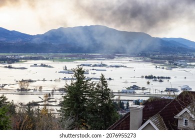 Abbotsford, Greater Vancouver, British Columbia, Canada - November 17, 2021: Devestating Flood and black smoke from fire in the city and farmland after storm.