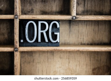 The abbreviation "DOT ORG" written in vintage metal letterpress type in a wooden drawer with dividers.