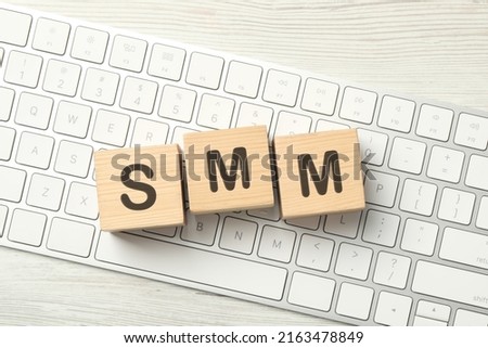 Abbreviation SMM made with wooden cubes on computer keyboard, top view. Social Media Marketing