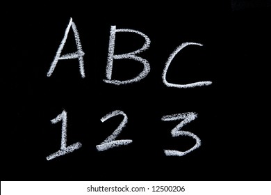 ABC 123 on a chalkboard in a classroom