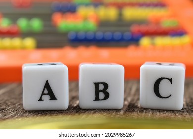 ABC in focus with abacus in background.