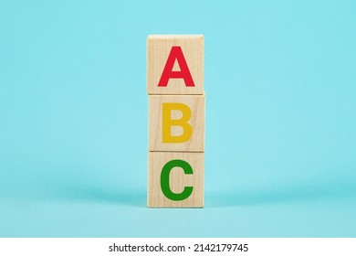 ABC on wooden blocks. ABC letters alphabet on wooden cube blocks in pillar form on blue background. Learn foreign languages. English for beginners. Copy the space - Shutterstock ID 2142179745