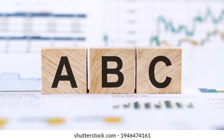 ABC word on wooden cubes. The background is a business graphs. Finance concept - Shutterstock ID 1946474161