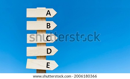 abcde lettered road sign and blue sky