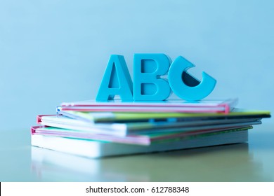 ABCs Symbols Placed On A Stack Of Educational Children's Books.