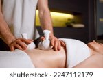 Abdominal massage with warm pindas at spa center