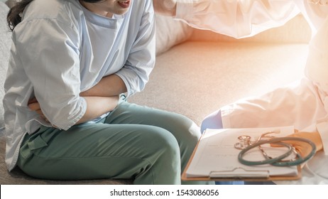 Abdominal Pain Patient Woman Having Medical Exam With Doctor On Illness From Stomach Cancer, Irritable Bowel Syndrome, Pelvic Discomfort, Indigestion, Diarrhea, GERD (gastro-esophageal Reflux Disease)