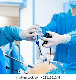 Abdominal surgery operation process using laparoscopic equipment. Selective focus. Hands of surgeons with surgical equipment. Surgical treatment of proctological diseases.