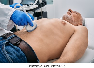 Abdominal ultrasound with ultrasound machine for male patient, close-up - Powered by Shutterstock