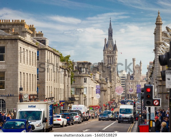 Aberdeen, Scotland, UK - July 31, 2019:\
Union Street with daily car traffic in Downtown Aberdeen City\
Centre with Aberdeen Town House, in Scotland,\
UK
