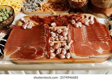 able with snacks and drinks. There are various types of snacks on the table, such as chips, nuts, crackers, dried fish and sausages.