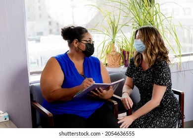 Abortion Care Patient And Friend In Abortion Clinic Waiting Room Signing Patient Journal