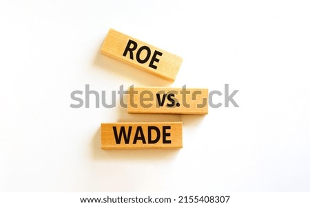Abortion process Roe versus Wade symbol. Concept words Roe versus Wade on wooden blocks. Beautiful white table white background. Abortion process Roe versus Wade concept. Copy space.