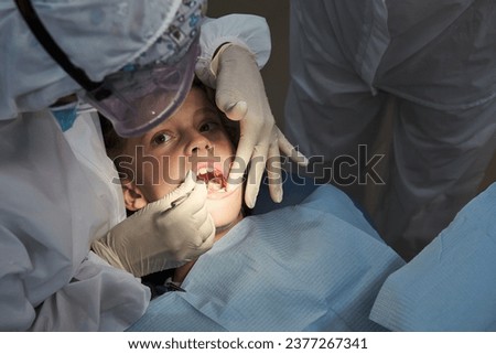 Similar – Image, Stock Photo Anonymous dentist treating teeth of patient