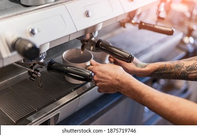 From Above Anonymous Tattooed Barista Pouring Coffee From Modern Coffeemaker Into Cups While Working In Cafeteria