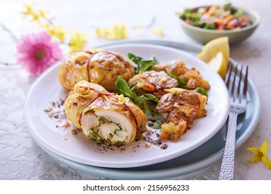 From above of appetizing stuffed chicken thighs served on plate with green herbs for lunch