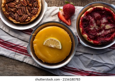 Above Baked Artisan Made Lemon Custard Tart, Pecan Tart, And Strawberry Tart