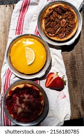 Above Baked Artisan Made Lemon Custard Tart, Pecan Tart, And Strawberry Tart