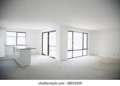 As Above - Black Stone Kitchen Bench Top, Unfinished Flooring, White Wall.