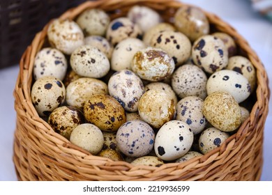 From Above Bunch Of Fresh Quail Eggs Placed Inside Wicker Basket On Market Stall