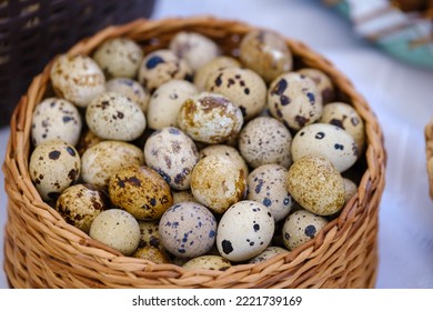 From Above Bunch Of Fresh Quail Eggs Placed Inside Wicker Basket On Market Stall