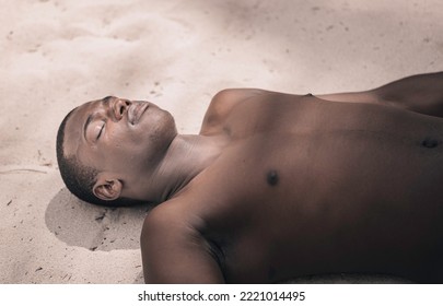 From Above Calm African American Male Tourist With Naked Torso Closing Eyes And Sunbathing While Lying On Sand On Weekend Day On Beach