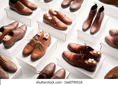 From above clean elegant shoes made of brown leather and placed on white containers