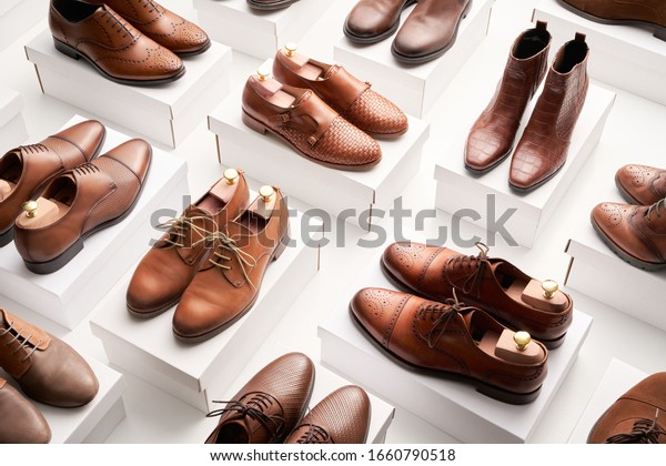 From above clean elegant shoes made of brown\
leather and placed on white\
containers