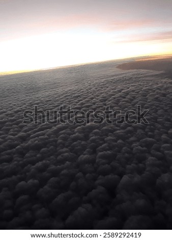 From above the clouds, the endless sky glows in shades of blue and gold. At this height, the world below fades, and the horizon stretches into a breathtaking masterpiece of light and space.