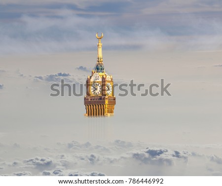 Above the clouds view of Abraj Al Bait Makkah Tower, (Royal Clock Tower Mecca) and dry mountains of holy city Saudi Arabia