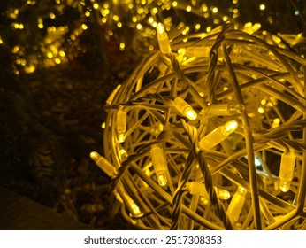 From above of decorated garland of ornamental glowing yellow shiny led lights illuminating in ball shape in festive season along with bokeh golden background at night - Powered by Shutterstock