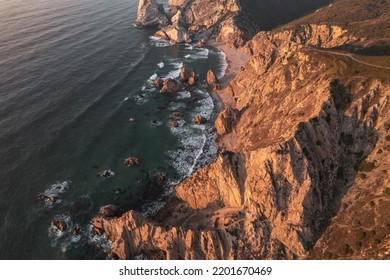 From Above Drone View Of Clean Sea Water Splashing Near Rough Cliffs And Ursa Beach In Portugal