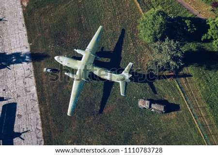 Above drone view onmilitary propeller transport aircraft. Military airfield