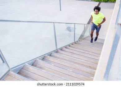 From Above Of Fit African American Male Runner Jogging Up Staircase During Cardio Training In City In Summer