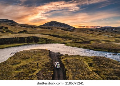 Above of four wheel drive vehicle parked by the big river crossing in the evening on remote rural at Icelandic Highlands