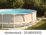 Above ground swimming pool outdoors on sunny day