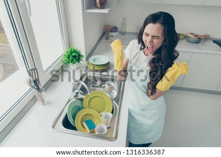 Above high angle view of her she attractive beautiful irritated annoyed fury frustrated devastated wavy-haired house-wife showing rage gesture near dirty plates pile in modern light white interior
