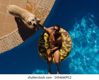 From Above A Man On Beach Mat In Swimming Pool Of A Villa House In A Sunny Day