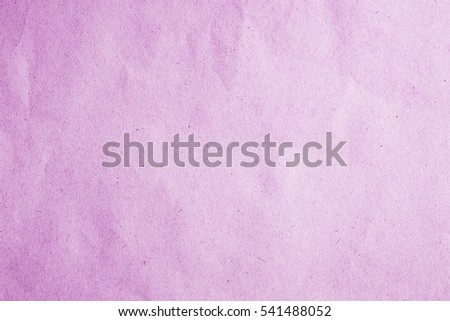 Above old scrap paper book kraft texture in soft light lavender color on vertical table top view concept for card board plain package background. Parchment recycle cardboard surface pale pink colour.