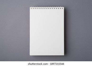 Above overhead close up flat lay mock up view photo of clear spiral notepad with copy space for design isolated grey desk - Shutterstock ID 1897215544