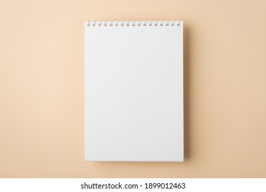 Above overhead close up flat lay mock up view photo of clear spiral notebook with copy space for design isolated pastel color backdrop desk