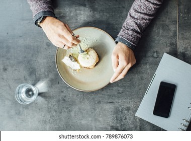 From Above Photo Of Hands Of Unrecognisable Man Eating Delicious Dessert At Restaurant.