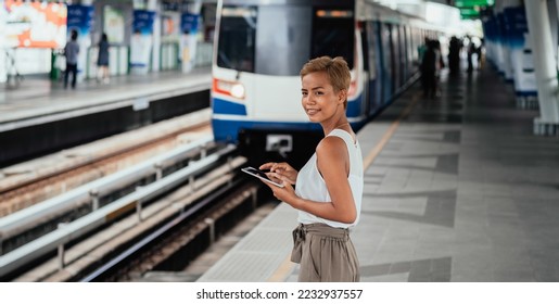 From Above Photo Of Happy Woman Using A Digital Tablet While Standing At Railway Platform - Shutterstock ID 2232937557