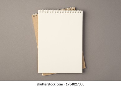 Above photo of two empty notebooks isolated on the grey background