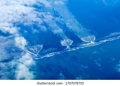 from above, river structure floating into the ocean of island